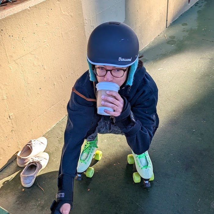 picture of me drinking chai while wearing roller skates